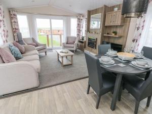 a living room with a table and a couch at Seahorse Retreat in Haverfordwest