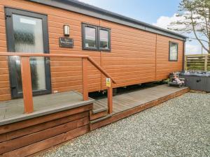 a wooden house with a staircase on the side of it at Seahorse Retreat in Haverfordwest