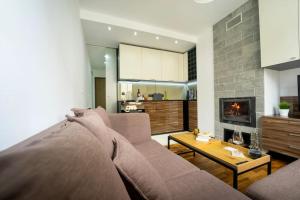 a living room with a couch and a fireplace at Secluded Mountain Cozy Studio with Fireplace in Bansko