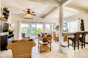 a living room with furniture and a ceiling fan at Suite A203 @ Mara Laguna in San Pedro