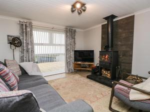 a living room with a couch and a fireplace at The Chalet in Egremont