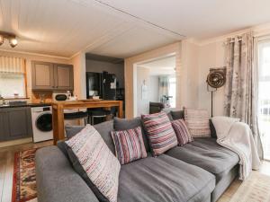 a living room with a gray couch with pillows at The Chalet in Egremont