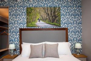 a bedroom with a bed with a blue and white wallpaper at The Woodborough Inn in Winscombe