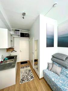 a kitchen with a sink and a bed in a room at Savi Apartment 2 in Pärnu +3 photos