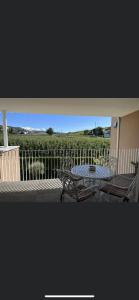 a patio with a table and chairs and a fence at Azalea in Cornaiano