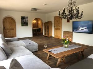 a living room with a couch and a table at Red Deer Resort in Bad Wiessee