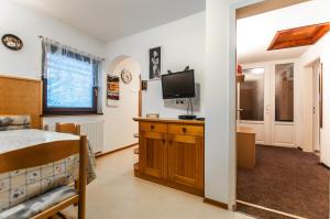 a bedroom with a bed and a tv on a cabinet at Apartment Ticar in Bohinj