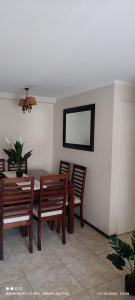 a dining room with a table and wooden chairs at Departamento Full 3D 2B Cerca de Playas en Arica in Arica