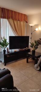 a living room with a large flat screen tv at Departamento Full 3D 2B Cerca de Playas en Arica in Arica