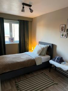 a bedroom with a bed and a window at Little gate in Ieper