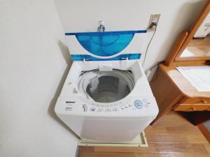 een wasmachine met een blauwe stoel in een badkamer bij Corp Temma - Vacation STAY 08144v in Takayama