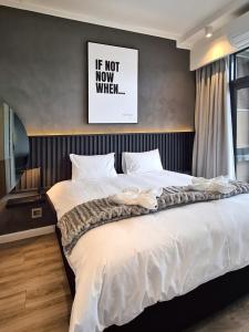 a large bed in a bedroom with a picture on the wall at 11 Floors in the Sky - Luxurious 1 Bedroom in Pretoria