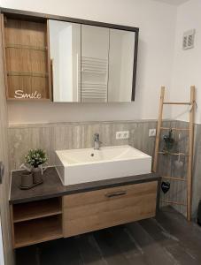 a bathroom with a white sink and a mirror at Appartement DOM II - Erfurt Domplatz in Erfurt