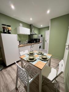 a kitchen with a table and chairs in a room at L'Oliveraie in Brioude