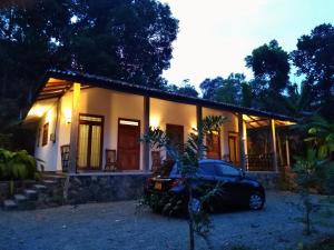 a house with a car parked in front of it at SKY Clouds Residencies Hikkaduwa in Hikkaduwa