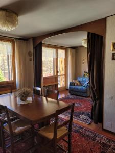a living room with a table and a couch at Over The Snow Apartment in Borgata Sestriere