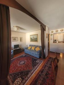 a living room with a bed and a rug at Over The Snow Apartment in Borgata Sestriere