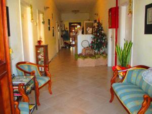 a living room with a christmas tree and a couch at Hotel Signorini in Castiglioncello
