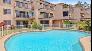 a swimming pool in front of a building at SeascapeatAlexBeach Budget Accomodation in Alexandra Headland