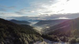 an aerial view of a valley in the mountains at Previja Zlatibor Chalet in Zlatibor