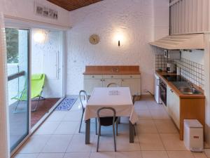 a kitchen with a table and chairs in a room at Maison Seignosse, 1 pièce, 5 personnes - FR-1-239-394 in Seignosse