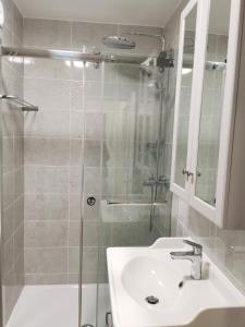 a bathroom with a glass shower and a sink at 1min BusStop to St Germain En Laye - Chambourcy Center - Wei&Pei Apartment in Chambourcy