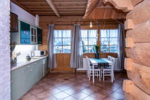 a kitchen and dining room with a table and chairs at Apartamenty Panorama in Kościelisko