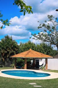 a gazebo next to a swimming pool at CORONADO VILLA VICTORIA in San Carlos