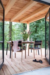 a wooden table and chairs on a wooden deck at Bosco Uno in Łagów +24 photos