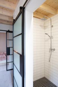 a bathroom with a shower and a glass door at Bosco Uno in Łagów