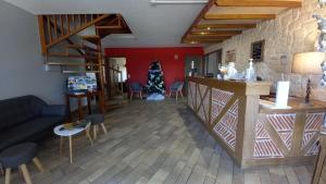 a living room with a christmas tree in a room at Etesia in Feurs