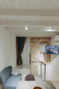 a living room with a couch and a flat screen tv at Amiura B&B in Corato