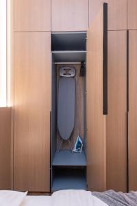 a small room with a bed inside of a cabinet at cohost I New Bastėja Life Apartments w-Garage Prkg & Self Check-in in Vilnius