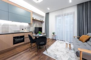 a living room with a couch and a table at cohost I New Bastėja Life Apartments w-Garage Prkg & Self Check-in in Vilnius