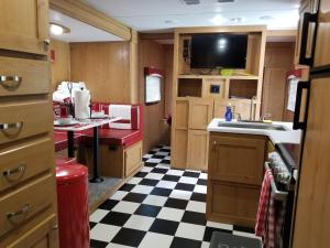 a kitchen with a black and white checkered floor at Umpqua's Last Resort - Wilderness Cabins, RV Park & Glamping in Idleyld Park