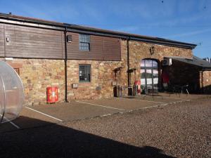 a brick building with a parking lot in front of it at Dandy Lodge, Bowness-on-Solway in Bowness-on-Solway