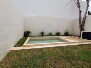 a swimming pool in the yard of a house at Casa Mara 53 Luxury House in downtown Mérida in Mérida