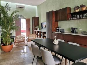 a kitchen and dining room with a table and chairs at Casa Mara 53 Luxury House in downtown Mérida in Mérida