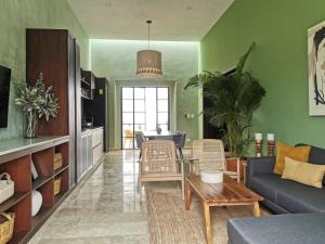 a living room with a couch and a table at Casa Mara 53 Luxury House in downtown Mérida in Mérida