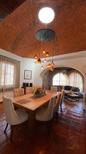 a dining room with a large wooden table and chairs at Casa Doña Elena in Bernal