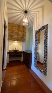 a bathroom with a vanity and a mirror on the wall at Casa Doña Elena in Bernal