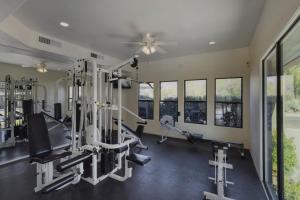 a gym with treadmills and machines and windows at Ventana Canyon Respite in Tucson