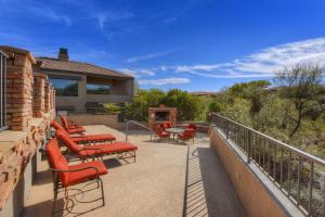a patio with red chairs and a table on a building at Ventana Canyon Respite in Tucson