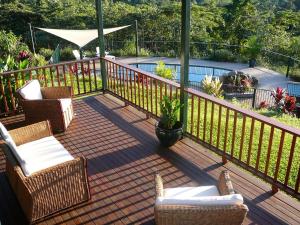 a deck with chairs and a swimming pool at Coral Sea Views in Diwan