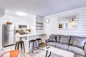 a living room with a couch and a kitchen at Carolina Beach Club, Unit 126 in Hilton Head Island