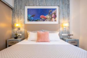 a bedroom with a large white bed with two lamps at Seafront Flat with Breathtaking Sea View in Bodrum in Bodrum City