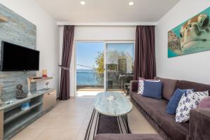 a living room with a couch and a table at Seafront Flat with Breathtaking Sea View in Bodrum in Bodrum City