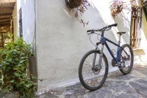ein blaues Fahrrad, das an einer weißen Wand geparkt ist in der Unterkunft Cozy House with Garden in Bodrum Bitez in Bitez