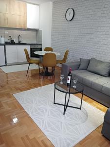 a living room with a couch and a table at Welcome Apartments in Niš