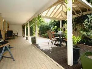 a large patio with a table and chairs at Lovely house in canning vale in Perth